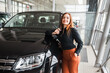 © Andrii  - Happy girl with a key in hands near her new car