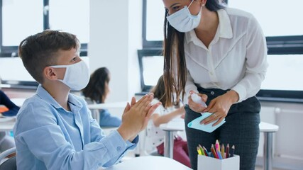 Poster - Teacher, children with face mask at school after lockdown, disinfecting hands.