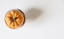 Top View Of Orange Decorative Pumpkin On White Background For Thanksgiving Holiday.