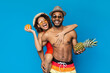 © Prostock-studio - Summertime. Cheerful african couple in swimwear with tropical fruits in hands