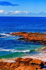 Sticker - Vertical shot of rock formations on the coast of the beautiful blue sea