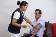 © Teran - nurse taking blood pressure to a patient at home