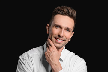 Poster - Portrait of handsome businessman on dark background