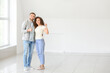 © Pixel-Shot - Happy young couple with key in their new flat