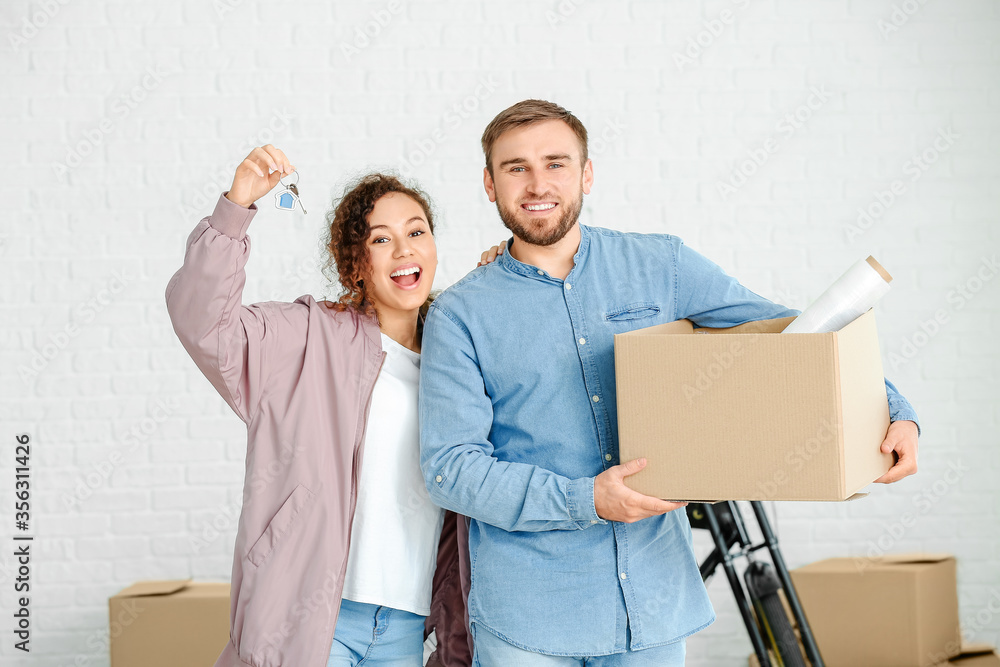 Young couple in their new flat on moving day