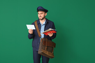 Canvas Print - Handsome young postman on color background