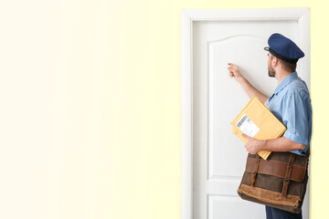 Canvas Print - Handsome young postman knocking at the door