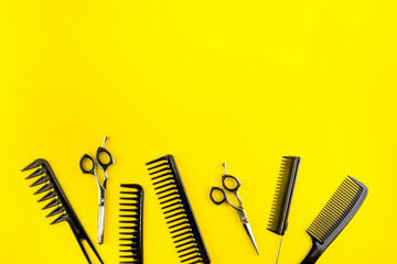 Wall Mural - Combs, hairbrush, scissors - hairdresser eqiupment - on yellow table top-down space for text