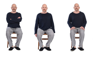 Wall Mural - group of same man in pajamas sitting o a chair on white background, front view