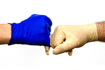 Wall Mural - hands in blue and white protective surgical gloves greet each other with little fingers.