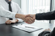 © Orathai - Friendly businessmen and executives shake hand after successful agreement with employment contracts, recruitment and employment concepts