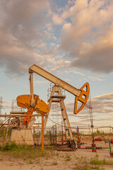 Wall Mural - Petroleum concept. Oil pump rig. Oil and gas production. Oilfield site. Pump Jack are running. Drilling derricks for fossil fuels output and crude oil production. Global crisis. War on oil prices.