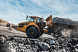 © timofeev - Large quarry dump truck. Loading the rock in dumper. Loading coal into body truck. Production useful minerals. Mining truck mining machinery, to transport coal from open-pit excavator work