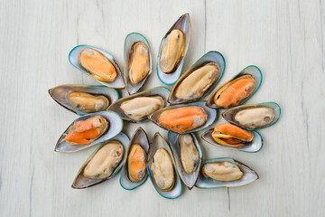 Sticker - Raw large mussels in half shell on wooden background