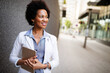 © NDABCREATIVITY - Beautiful happy professional business woman smiling happy with tablet outdoor