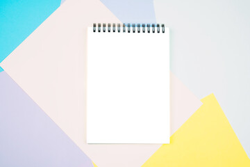 White sheet of notepad on a colored geographic background.