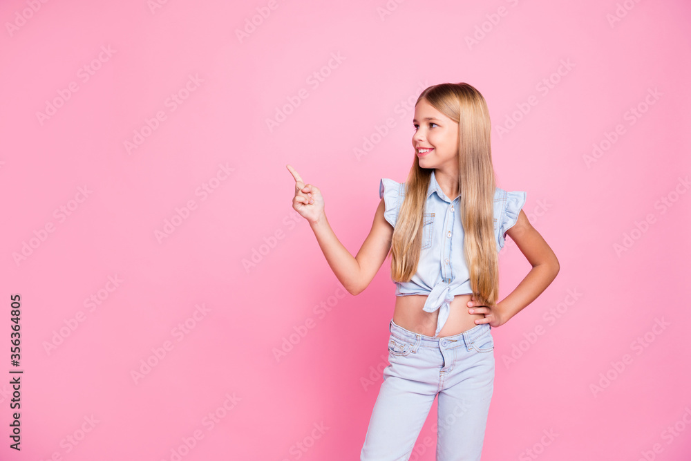 Portrait of positive confident kid girl promoter point index finger copyspace demonstrate advert promotion wear stylish trendy clothes isolated over pastel color background - obrazy, fototapety, plakaty 