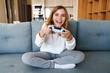 © Drobot Dean - Photo of excited nice girl smiling and playing video game with joystick