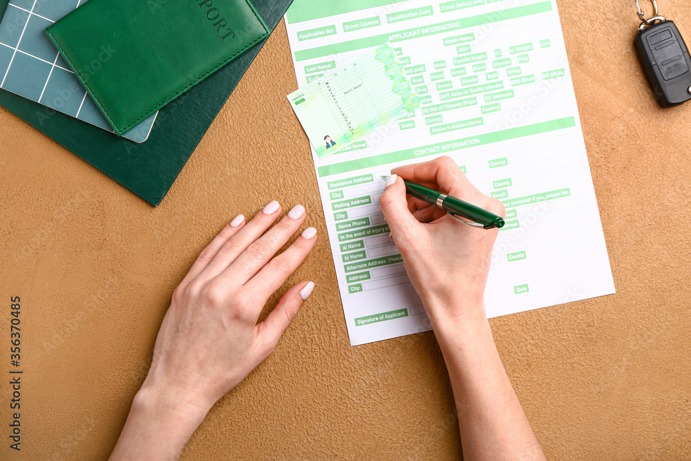 Woman filling in driver license application at table