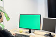 © Daniel Mato - Man at his workplace with a computer and a green screen