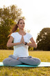 © Andrei KOSCINA - Young woman doing yoga and stretching in the park