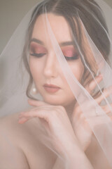 Wall Mural - Bride with bright pink makeup and pearl earrings dreams with her eyes closed