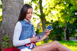 © Andrei KOSCINA - Yung woman playing ukelele in London under a tree