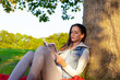 © Andrei KOSCINA - Young Latin woman reading under a tree