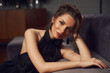 © Dmitry Tsvetkov - Closeup face portrait of young stylish fashionable woman with makeup and hairstyle wearing earrings and black dress