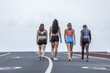 © Juan Algar - Unrecognizable diverse female athletes walking on road