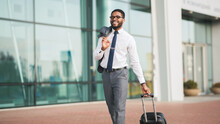 Happy Businessman Walking At Airport With Travel Suitcase, Panorama