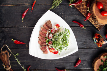 Wall Mural - Gourmet roast beef with arugula and tomato salad