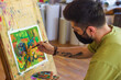 © Gegham - artist at work, young artist with protective mask painting a picture