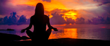 Woman Meditating, Relaxing In Yoga Pose At Sunset, Zen Meditation. Silhouette In Lotus Pose. Mind Body Spirit Concept