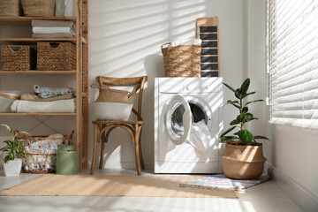 Sticker - Modern washing machine and plants in laundry room interior