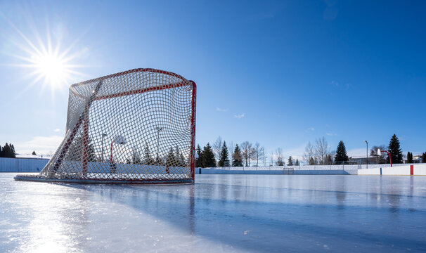 hockey net on clear sunny winter day with sunburst on fresh ice