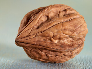 Wall Mural - Walnuts lie on a colored wooden background.Nuts are good for your health.Vegan