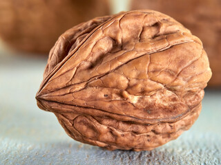 Wall Mural - Walnuts lie on a colored wooden background.Nuts are good for your health.Vegan