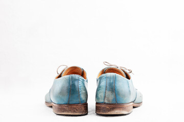 Pair of old leather blue discarded boots with laces