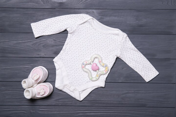 Wall Mural - Baby clothes on a gray background. Place for text. Flat lay