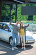 © zinkevych - Happy cheerful man and woman near car outdoors