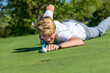 © ARochau - Spaß beim Golf-Spiel - Teenager beim einlochen in Billard-Manier