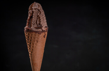 Decorative chocolate ice cream dessert in a cone