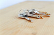 © Yuranan - Bunch of keys on a shaped keychain at wooden table background. Concept for real estate or renting home with copy space,Close up.