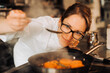 © Cavan Images - Female chef is checking cooked apricot confiture