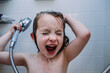 © Cavan Images - close up of young child singing in shower while washing hair