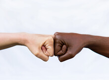 Two Hands Of Different Racial Colors, Punching Each Other, Expressing Victory, Agreement, Partnership. The Concept Of Ending Racism