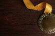 Gold medal with ribbon on wooden background, flat lay. Space for design