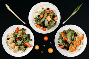 healthy tasty food on a white plate lies on a black background.