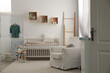 © New Africa - Stylish baby room interior with crib and armchair